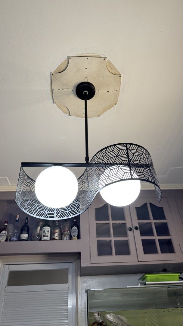 Modern Black Geometric Chandelier with Globe Lights (Category: Lighting) located in Manila. Submitted by janna.ali (Listing ID 1462600117, Image 1). Description: - Unique wavy black metal shade with geometric cutouts - Two frosted globe lights for soft illumination - Modern and artistic design - Ideal for dining areas or living rooms - Easy installation.