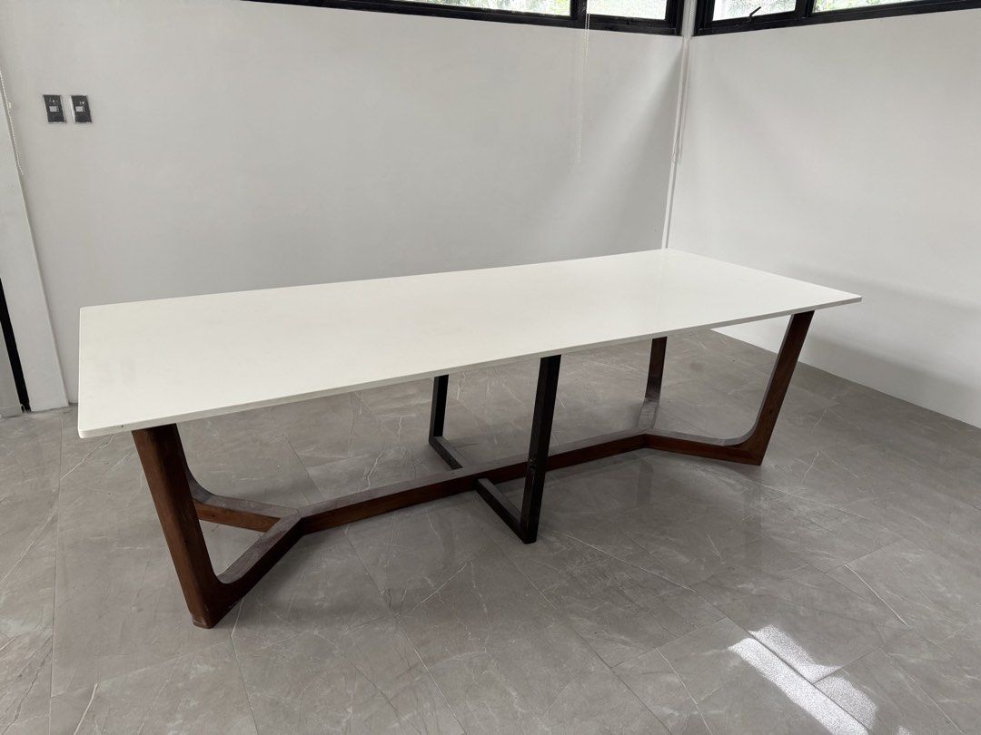 Long, Custom Dining Table with White Quartz Top and Solid Wood Base (Category: Tables & Sets) located in Quezon City. Submitted by applesvee (Listing ID 1462544036, Image 1). Description: - warm minimalist dining table with a sleek white quartz top -Dimensions: 2.70m L x 1.00m W x .75m Ht. - Sturdy and stylish solid wood base. - Comfortably seats 10-12 people. - Perfect for contemporary home aesthetics..