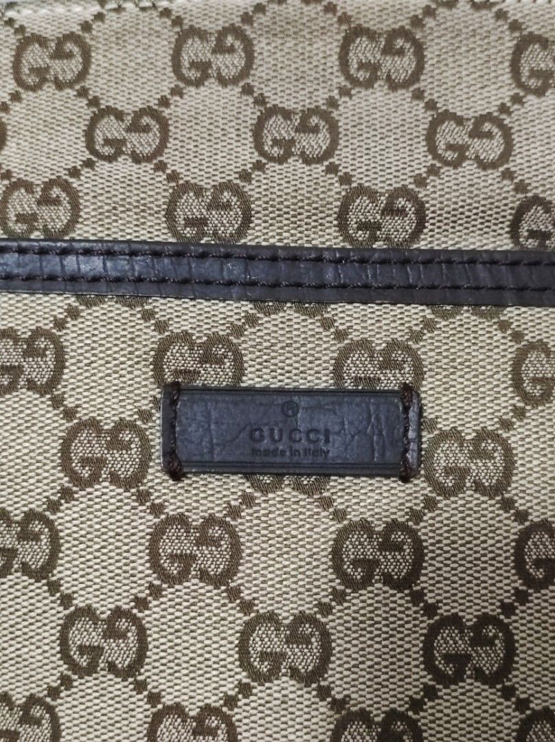 Monogram Flat Messenger Bag Dark Brown (Category: Luxury Bags & Wallets) located in Santa Rosa. Submitted by sassycollection. (Listing ID 1462460879, Image 2). Description: This is a GUCCI Monogram Flat Messenger Bag in Dark Brown. This stylish messenger bag is crafted of GG monogram canvas in brown. The bag features dark brown leather trim, a nylon crossbody strap with a silver adjustment buckle, and a front pocket. The top zipper opens to a dar