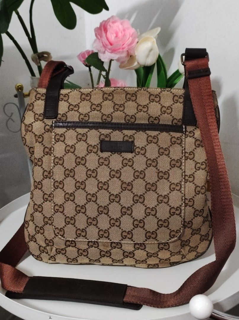 Monogram Flat Messenger Bag Dark Brown (Category: Luxury Bags & Wallets) located in Santa Rosa. Submitted by sassycollection. (Listing ID 1462460879, Image 1). Description: This is a GUCCI Monogram Flat Messenger Bag in Dark Brown. This stylish messenger bag is crafted of GG monogram canvas in brown. The bag features dark brown leather trim, a nylon crossbody strap with a silver adjustment buckle, and a front pocket. The top zipper opens to a dar