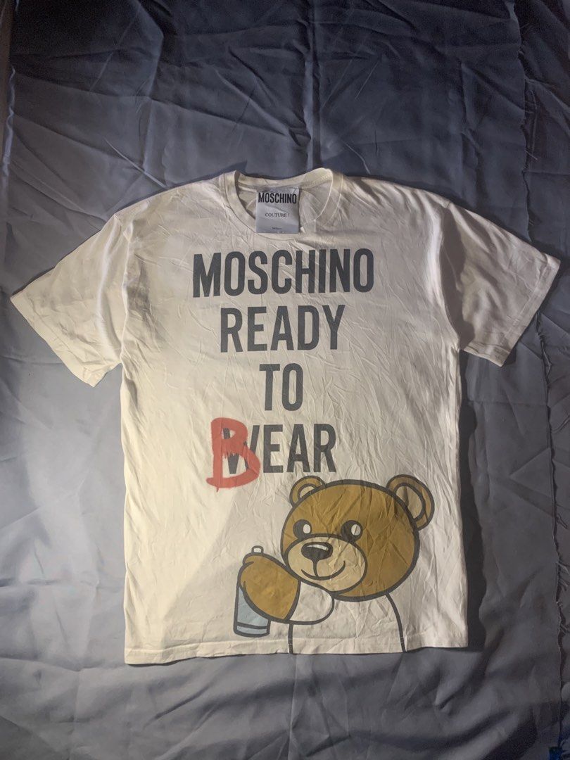 Moschino ready to bear shirt (Category: Luxury Apparel) located in General Santos City (Dadiangas). Submitted by stockyards (Listing ID 1462558866, Image 1). Description: Brand: moschino • excellent | no issue • 9.5/10 color rate • need wash * FREESHIPPING PH Actual dimes Width: 21 Length: 28 Price: 749 General santos city mindanao 9500📍 .
