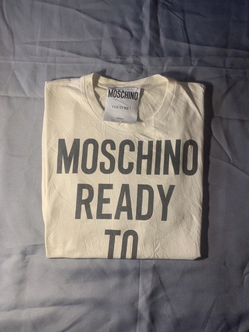 Moschino ready to bear shirt (Category: Luxury Apparel) located in General Santos City (Dadiangas). Submitted by stockyards (Listing ID 1462558866, Image 2). Description: Brand: moschino • excellent | no issue • 9.5/10 color rate • need wash * FREESHIPPING PH Actual dimes Width: 21 Length: 28 Price: 749 General santos city mindanao 9500📍 .