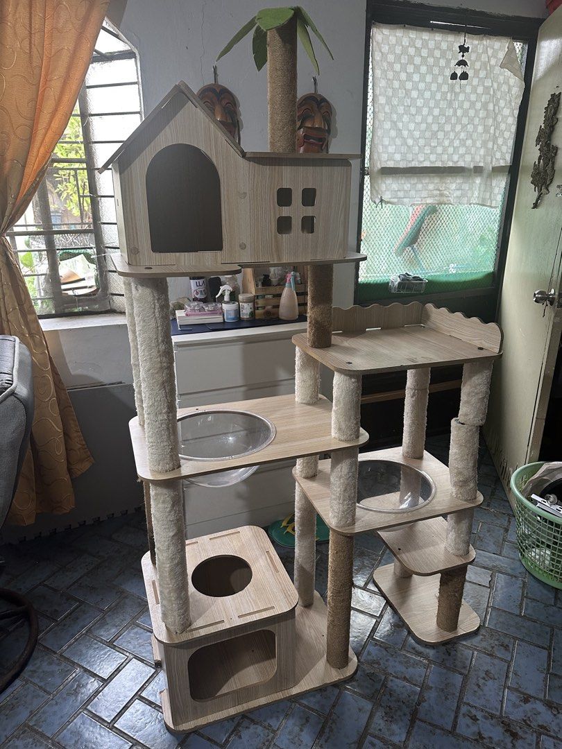 Multi-Level Cat Tree Condo with Hammocks and Perches (Category: Homes & Other Pet Accessories) located in San Pedro. Submitted by mysticdog_8deb08 (Listing ID 1462515338, Image 2). Description: - Bought at Amazon for 8,000 - Height 5’6 - Tall cat tree with multiple levels for climbing and lounging. - Features cozy hideaways for napping. - Includes scratching posts to satisfy natural instincts. - Stylish wooden design complements home decor. - Stu