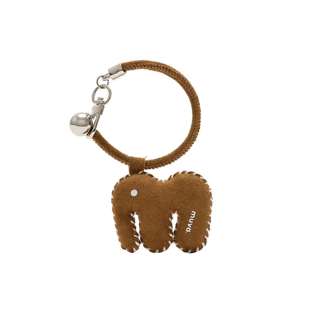 Muva. Elephant Charm Keychain with Bell (Category: Other Stationery & Craft) located in Manila. Submitted by litphilofashion (Listing ID 1462641468, Image 1). Description: - Adorable elephant charm keychain - Made of brown suede with white stitching, also available in Red - Features a small, tinkling bell - 'Muva.' brand detail - Ideal accessory for bags or keys.