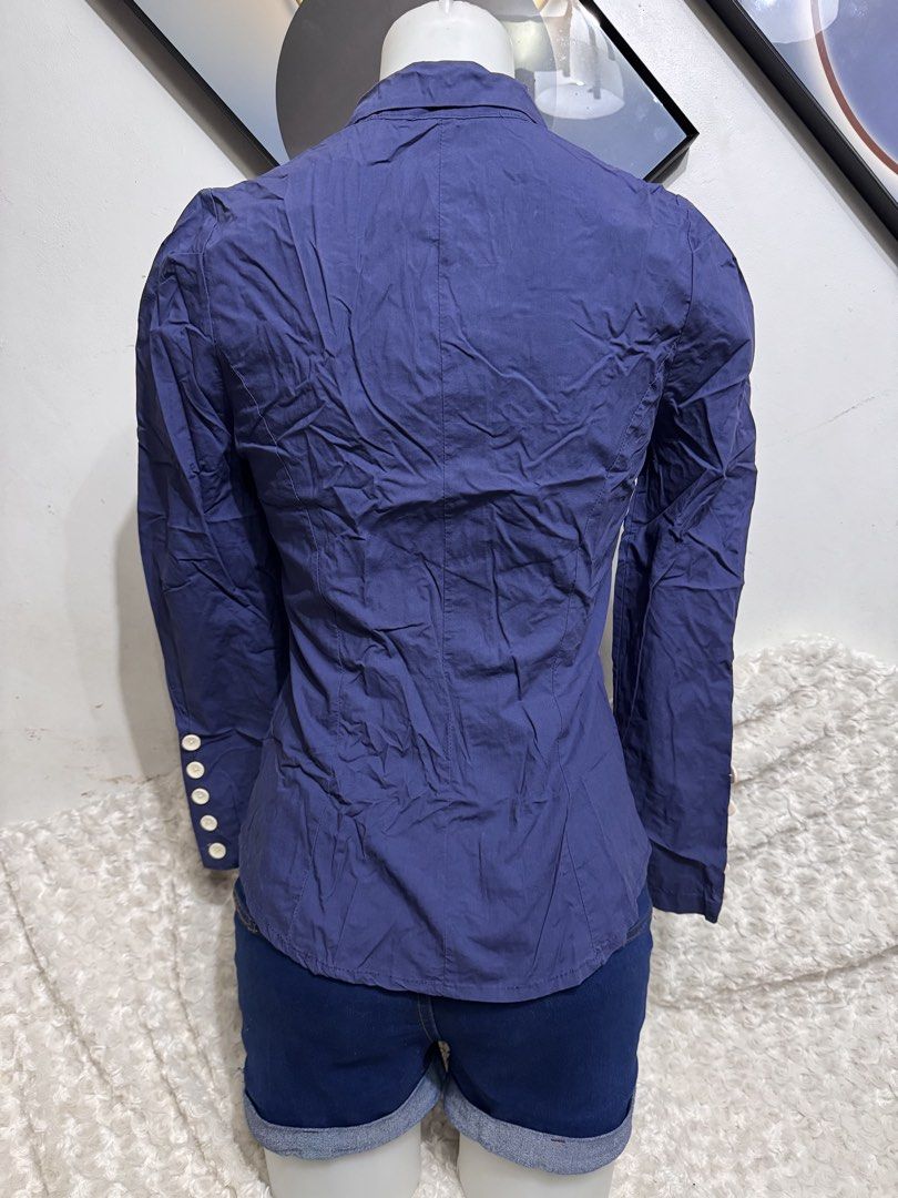 Navy Blue Button-Up Blouse with Collar Detail (Category: Longsleeves) located in Marikina City. Submitted by lorradel (Listing ID 1462459857, Image 3). Description: - fits s-m - Navy blue long-sleeved blouse - Unique stand-up collar with button details - Button-up front with ruched detailing - Button accents on cuffs - Versatile: pairs well with shorts or jeans - MAY HAVE some washable stains (hindi maiiwasan) needs washing; had been stored - man