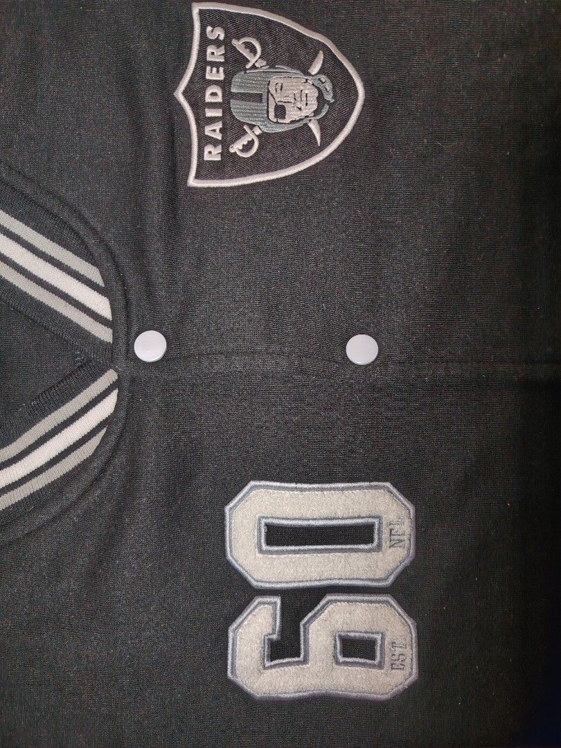 NFL Las Vegas Raiders Varsity Jacket XL (Category: Coats, Jackets and Outerwear) located in Manila. Submitted by charlize.kate2026 (Listing ID 1462471133, Image 2). Description: - Black and grey Las Vegas Raiders varsity jacket - Features Raiders logo on chest - 'Raiders' embroidered on sleeve - Number '60' on the front - NFL Team Apparel tag - Ribbed cuffs and collar for a snug fit - Classic snap button closure.