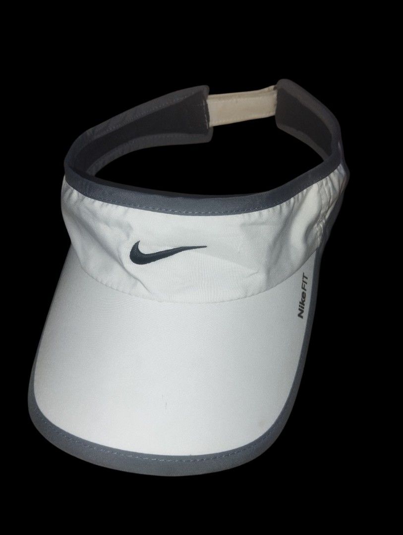 Nike Fit White Visor with Grey Trim (Category: Activewear) located in Manila. Submitted by thriftjepo01336 (Listing ID 1462519873, Image 1). Description: - White Nike visor with grey trim - Features Nike Fit logo on the side - Adjustable strap at the back for a secure fit - Ideal for sports activities or protecting your eyes from the sun - Lightweight and easy to wear.