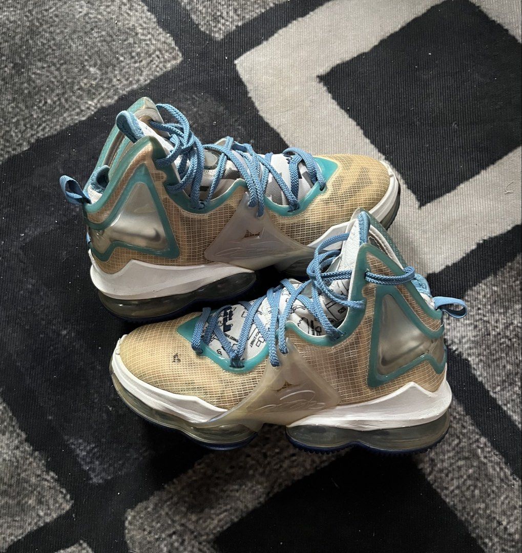 Nike LeBron 19 "Space Jam" | Size 40.5 (Category: Sneakers) located in General Trias. Submitted by zrchustle.604 (Listing ID 1462624898, Image 1). Description: Nike LeBron 19 "Space Jam" (Sweatsuit) high-top basketball sneakers. This specific colorway features a cream/tan mesh upper, wrapped in clear TPU window panels along the ankle and midfoot. Bright Dutch Blue accents cover the laces, interior lining, and collar piping. The graphic prints vis