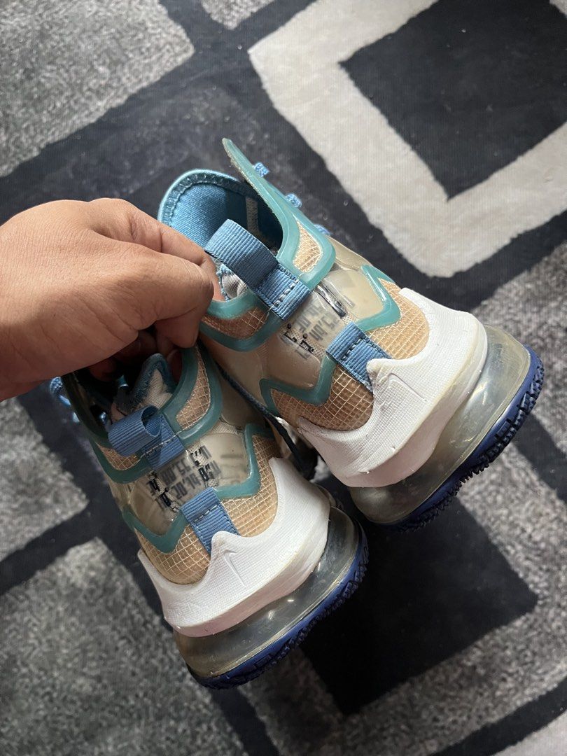 Nike LeBron 19 "Space Jam" | Size 40.5 (Category: Sneakers) located in General Trias. Submitted by zrchustle.604 (Listing ID 1462624898, Image 3). Description: Nike LeBron 19 "Space Jam" (Sweatsuit) high-top basketball sneakers. This specific colorway features a cream/tan mesh upper, wrapped in clear TPU window panels along the ankle and midfoot. Bright Dutch Blue accents cover the laces, interior lining, and collar piping. The graphic prints vis