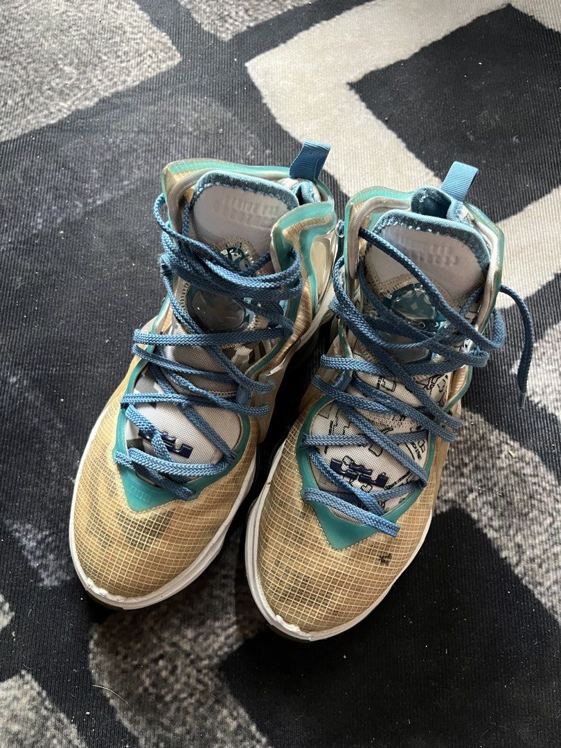 Nike LeBron 19 "Space Jam" | Size 40.5 (Category: Sneakers) located in General Trias. Submitted by zrchustle.604 (Listing ID 1462624898, Image 2). Description: Nike LeBron 19 "Space Jam" (Sweatsuit) high-top basketball sneakers. This specific colorway features a cream/tan mesh upper, wrapped in clear TPU window panels along the ankle and midfoot. Bright Dutch Blue accents cover the laces, interior lining, and collar piping. The graphic prints vis