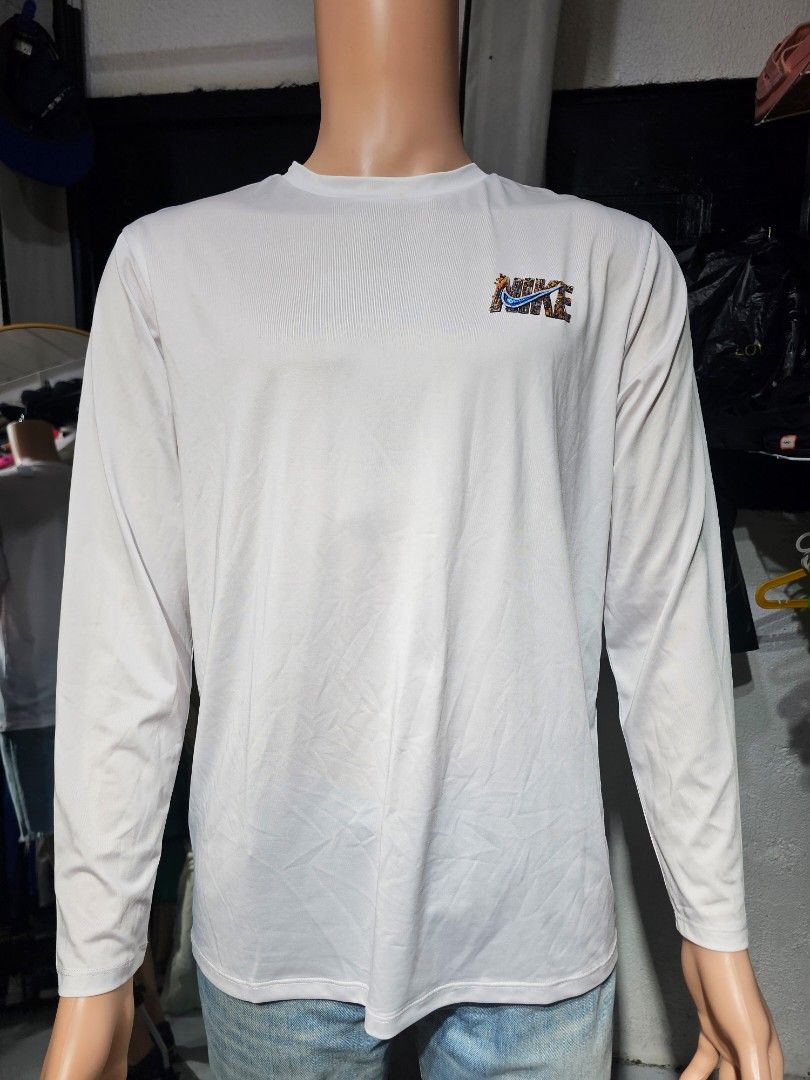 Nike long sleeve (Category: Coats, Jackets and Outerwear) located in Baguio. Submitted by kayeonlineshop (Listing ID 1462504575, Image 2). Description: -white long-sleeve Nike shirt featuring a small, multicolored patterned chest logo -measurements included in the photos.