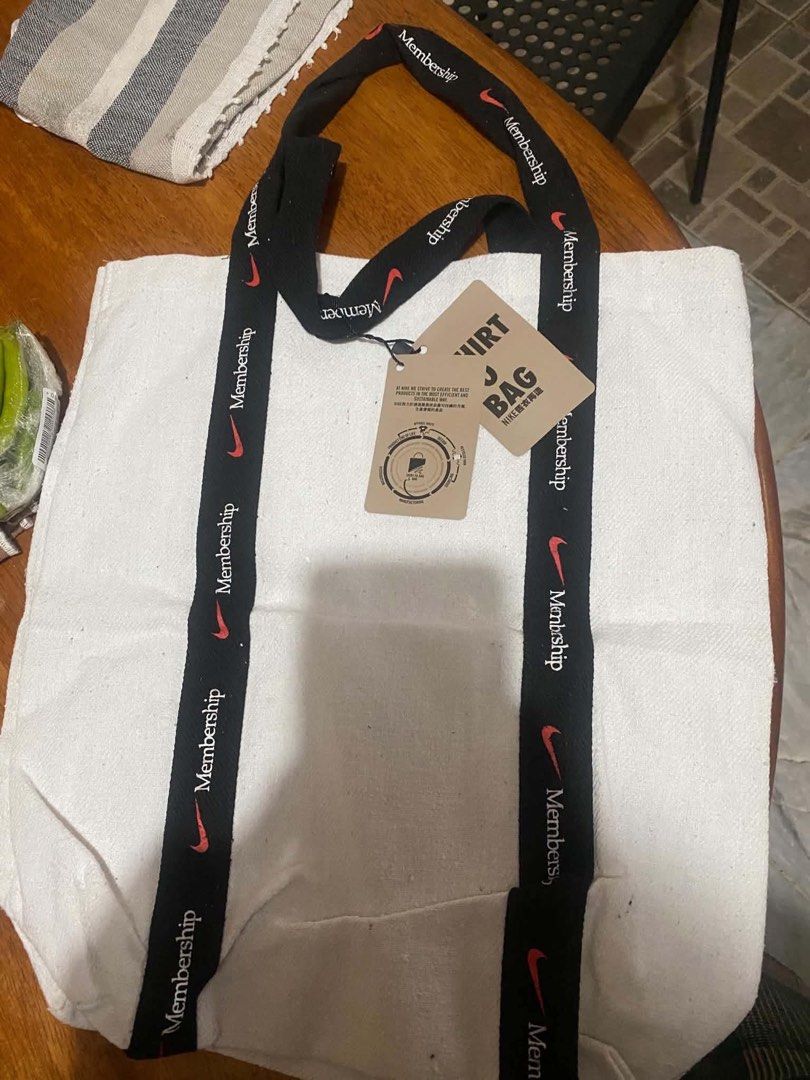 Nike Membership Tote Bag (Category: Tote Bags) located in Manila. Submitted by netgnet (Listing ID 1462449292, Image 1). Description: - White canvas tote bag - Black straps with repeated 'Membership' and Nike swoosh print - Brand new with original tags - Ideal for everyday use or shopping - Spacious and durable design.