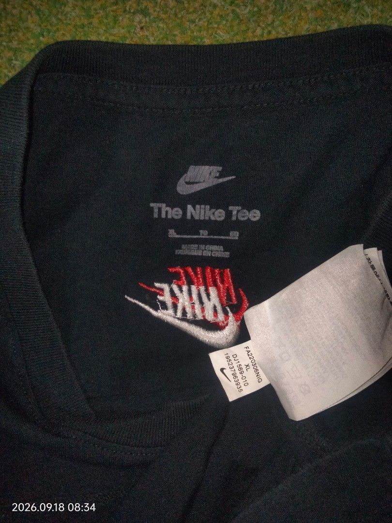 Nike multiple logo (Category: Tshirts & Polo Shirts ) located in Caloocan City. Submitted by haruconcep52476 (Listing ID 1461219730, Image 3). Description: Nike multiple logo Dimensions W20.5×L27 Good condition Color rate 9 Need wash fresh from bale - Black Nike t-shirt - Features multiple small Nike logos on the front - One small Nike logo on the sleeve - Nike Tee label visible inside - Made in China - Perfect for casual everyday wear.