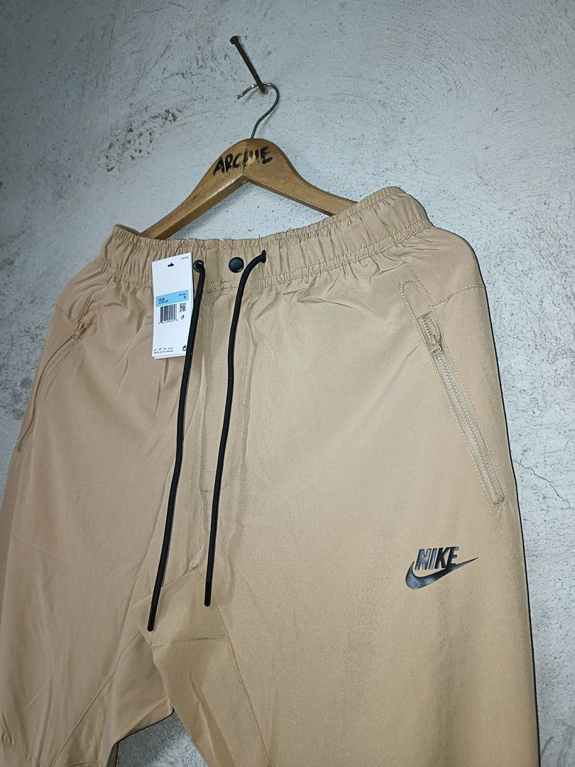 Nike woven Cargo Pants Khaki Size M (Category: Joggers) located in Quezon City. Submitted by stre3tw3ar (Listing ID 1462614287, Image 2). Description: - Brand new Nike woven cargo pants - Color: Khaki - Size: Medium (M) - Features elastic waistband with drawstring - Zipped pockets on the sides - Perfect for everyday wear or workouts - Tags attached.