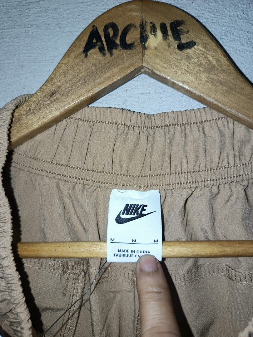 Nike woven Cargo Pants Khaki Size M (Category: Joggers) located in Quezon City. Submitted by stre3tw3ar (Listing ID 1462614287, Image 3). Description: - Brand new Nike woven cargo pants - Color: Khaki - Size: Medium (M) - Features elastic waistband with drawstring - Zipped pockets on the sides - Perfect for everyday wear or workouts - Tags attached.
