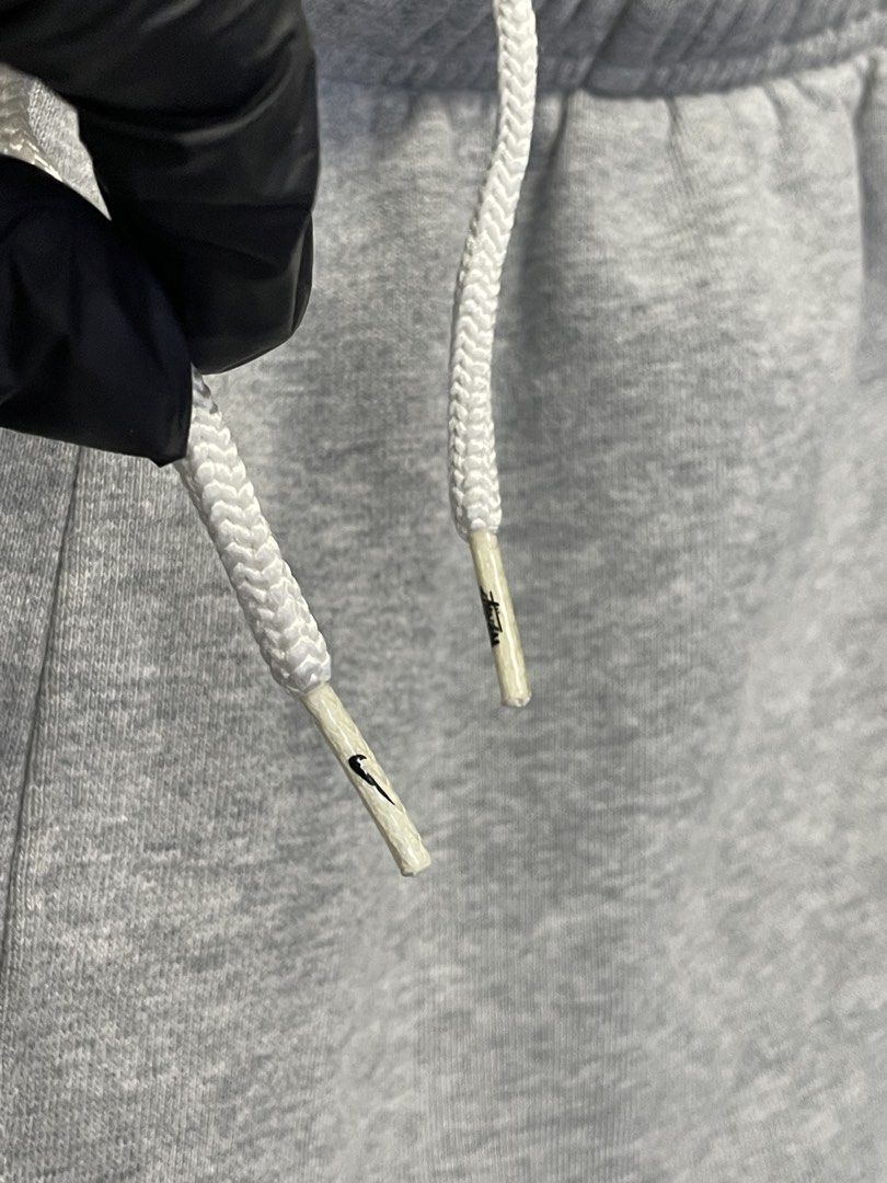 Nike x Stussy Grey Sweatpants Size M (Category: Joggers) located in Manila. Submitted by cis_thrift143 (Listing ID 1462533202, Image 3). Description: - Authentic Nike x Stussy collaboration grey sweatpants. - Features the iconic Stussy logo combined with the Nike swoosh. - Adjustable drawstring waist for a comfortable, personalized fit. - Elasticated cuffs for a snug and stylish look. - Size: Medium. - Ideal for everyday casual wear and streetwea