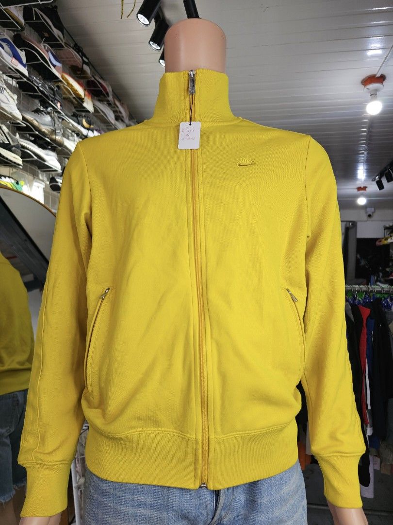 Nike zip-up track jacket (Category: Coats, Jackets and Outerwear) located in Baguio. Submitted by kayeonlineshop (Listing ID 1462461689, Image 2). Description: -yellow Nike zip-up track jacket featuring a high stand-up collar and a small embroidered logo on the chest.