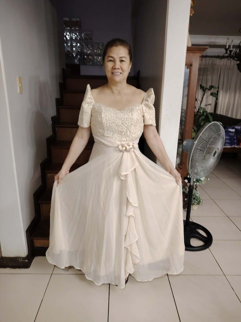 Ninang outfit (Category: Dresses) located in Quezon City. Submitted by viviandbarranda (Listing ID 1462625192, Image 1). Description: - Cream-colored Filipiniana dress - Detailed lace bodice - Puff sleeves - Flowy skirt with front ruffles - Zipper closure at the back - Ideal for formal events and cultural celebrations - Comfortable to wear.