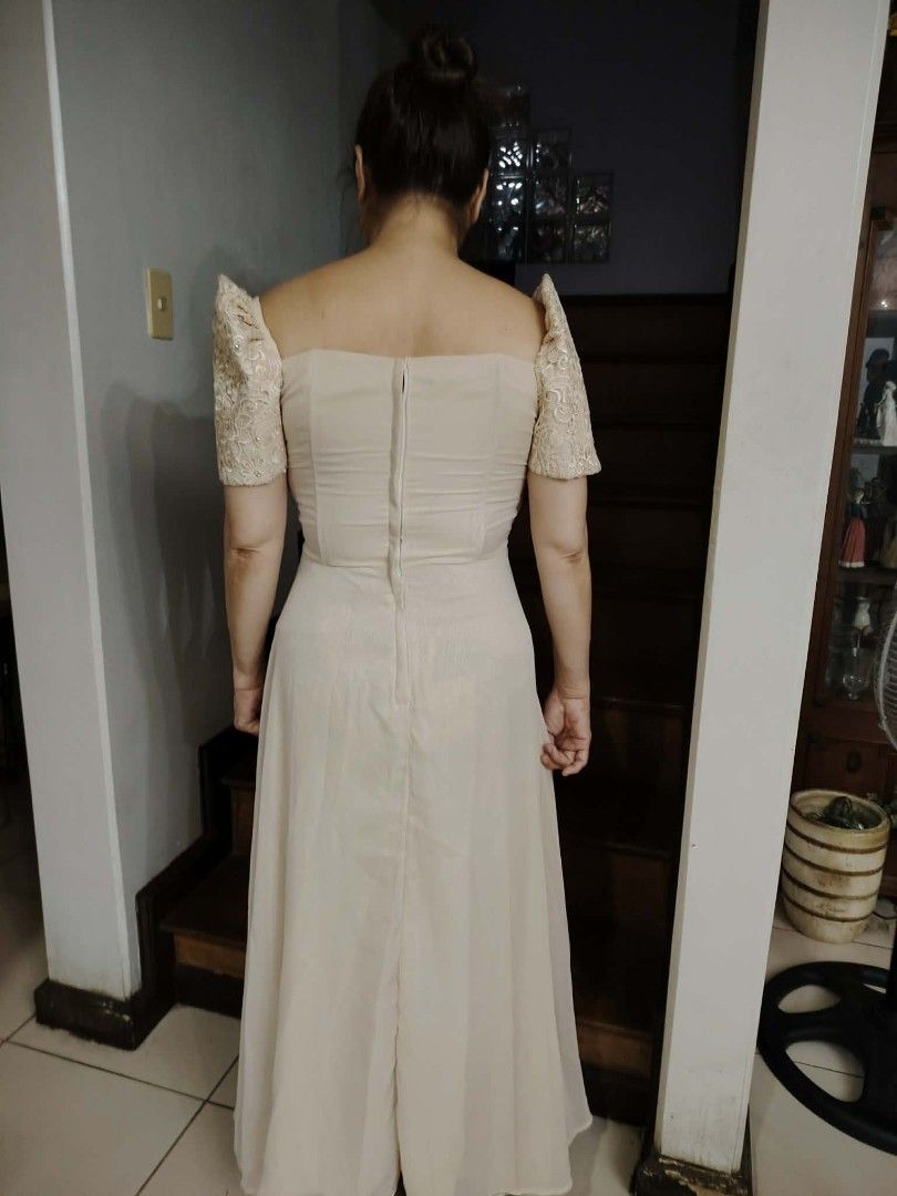 Ninang outfit (Category: Dresses) located in Quezon City. Submitted by viviandbarranda (Listing ID 1462625192, Image 3). Description: - Cream-colored Filipiniana dress - Detailed lace bodice - Puff sleeves - Flowy skirt with front ruffles - Zipper closure at the back - Ideal for formal events and cultural celebrations - Comfortable to wear.