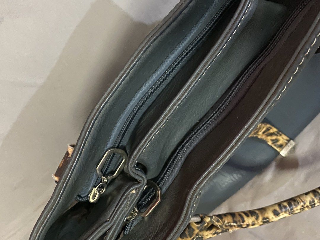Nine West Leopard Office Bag (Category: Shoulder Bags) located in Rizal. Submitted by ciciloved (Listing ID 1462620086, Image 3). Description: Authentic from US:) Comes with long strap. Issue: Minimal leather cracks on handle and back pocket zipper not working. See photos for details. Payment first to reserve. 📍Cainta Rizal 🛵 J&t or Lalamove only 💳 Strictly via GoTyme only.