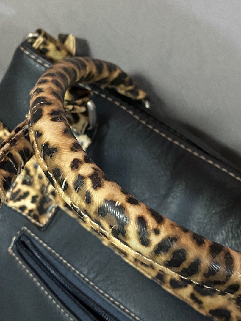Nine West Leopard Office Bag (Category: Shoulder Bags) located in Rizal. Submitted by ciciloved (Listing ID 1462620086, Image 2). Description: Authentic from US:) Comes with long strap. Issue: Minimal leather cracks on handle and back pocket zipper not working. See photos for details. Payment first to reserve. 📍Cainta Rizal 🛵 J&t or Lalamove only 💳 Strictly via GoTyme only.