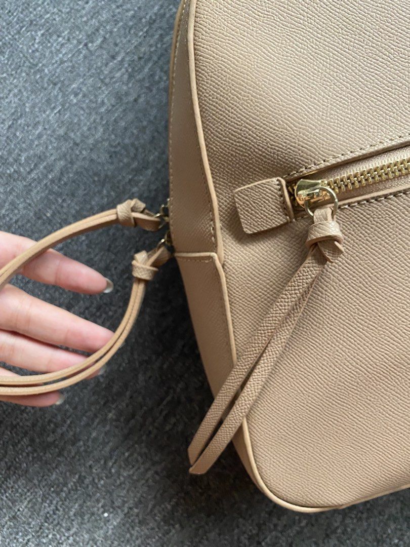 Nude Leather Mini Backpack (Category: Backpacks) located in Makati City. Submitted by clutterfree.life (Listing ID 1462515136, Image 3). Description: - Color: Nude - Size: 11” x 10” x 3” - Has internal pockets, one with zipper - Has zippered front pocket - Has slight discoloration on straps because of metal oxidation. Used once. .