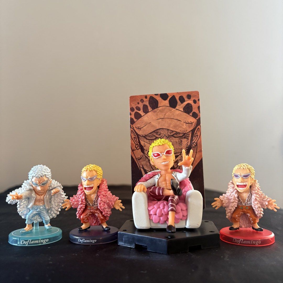 One Piece Doflamingo Figures Set (Category: Figurines & Statues) located in Manila. Submitted by tj.merch (Listing ID 1462576065, Image 1). Description: - Set of 4 Donquixote Doflamingo figures from One Piece. - Includes 1 seated Doflamingo figure with a throne and backdrop. - Features 3 additional standing Doflamingo figures. - All figures are clearly marked with 'Doflamingo' on their bases. - A must-have collectible for any dedicated One Piece 