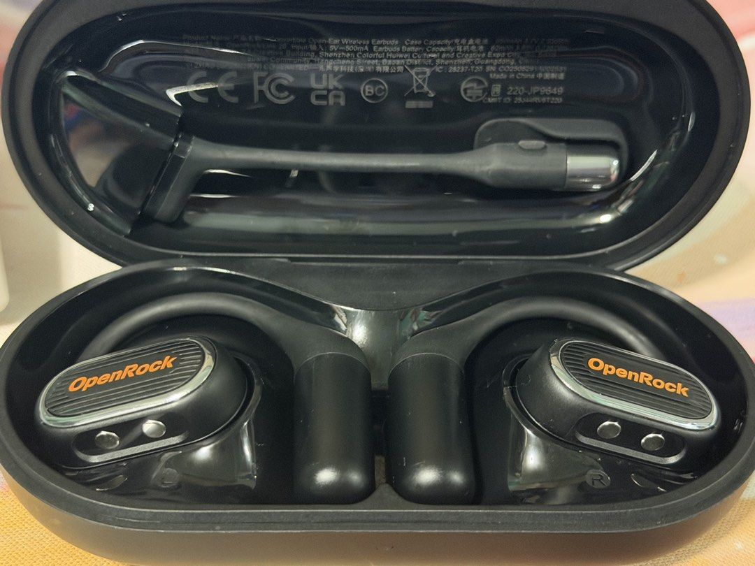 OpenRock Wireless Earbuds with Charging Case (Category: Earphones) located in Manila. Submitted by mcasensi (Listing ID 1462566539, Image 1). Description: - OpenRock wireless earbuds - Color: Black with orange accents - Includes charging case and charging cable - Ideal for workouts and daily use - Tested and confirmed working.