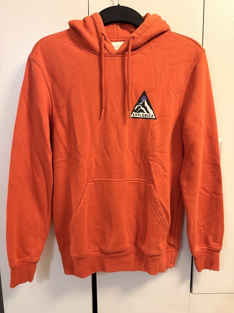 H&M Orange Hoodie (Category: Coats, Jackets and Outerwear) located in Makati City. Submitted by aeboi08 (Listing ID 1462629679, Image 1). Description: - H&M Cozy orange hoodie - XS/S - Features a cool mountain graphic on the chest - Convenient front pocket - Adjustable hood with drawstrings - Ideal for casual and warm wear.