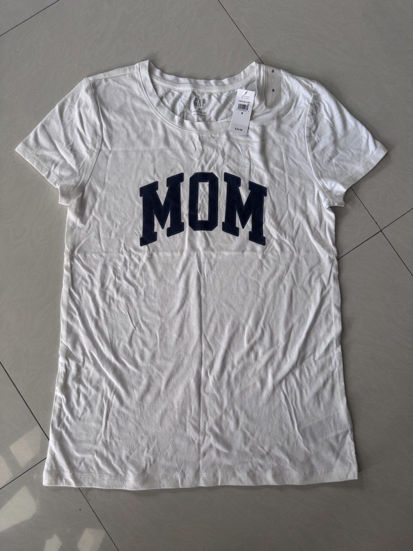 Original GAP “MOM” print shirt (Category: Shirts) located in Paranaque City. Submitted by happymommy2828 (Listing ID 1462471238, Image 1). Description: Original with tag and size sticker! -Size Small -Gusot lang but still can be given as a gift to someone :) .