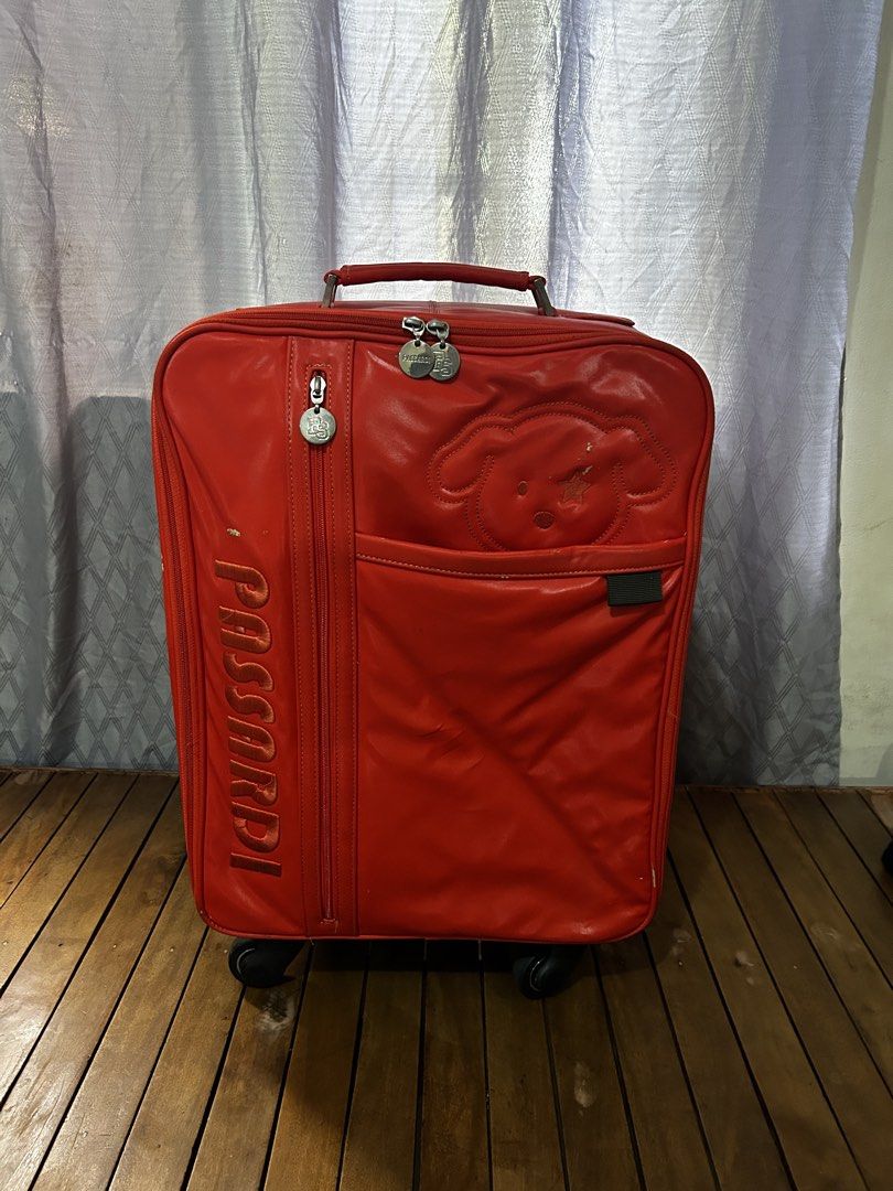 PASSARDI Carry on Luggage (Category: Luggage) located in Taguig. Submitted by ghiebow06 (Listing ID 1462613077, Image 1). Description: Dimensions: H- 21 W- 14 D- 7 Issue: scratches - Features a cute bear design on the front pocket - Retractable handle and wheels for easy transport - Shows some scuffs and wear marks on exterior (bottom/corners) - Zippers are functional - Ideal for travel.