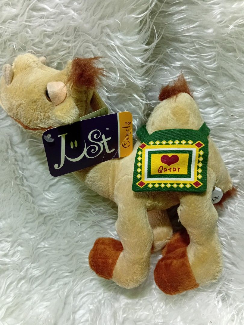 Peluche camello by Humphrey (Category: Plushies & Soft Toys) located in Caloocan City. Submitted by aims90 (Listing ID 1462624273, Image 1). Description: - Adorable camel plush toy - Features a saddle with 'I love. Qatar' detail - Comes with original tags attached - Exceptionally soft and cuddly material - Perfect for plush collectors or as a thoughtful gift.