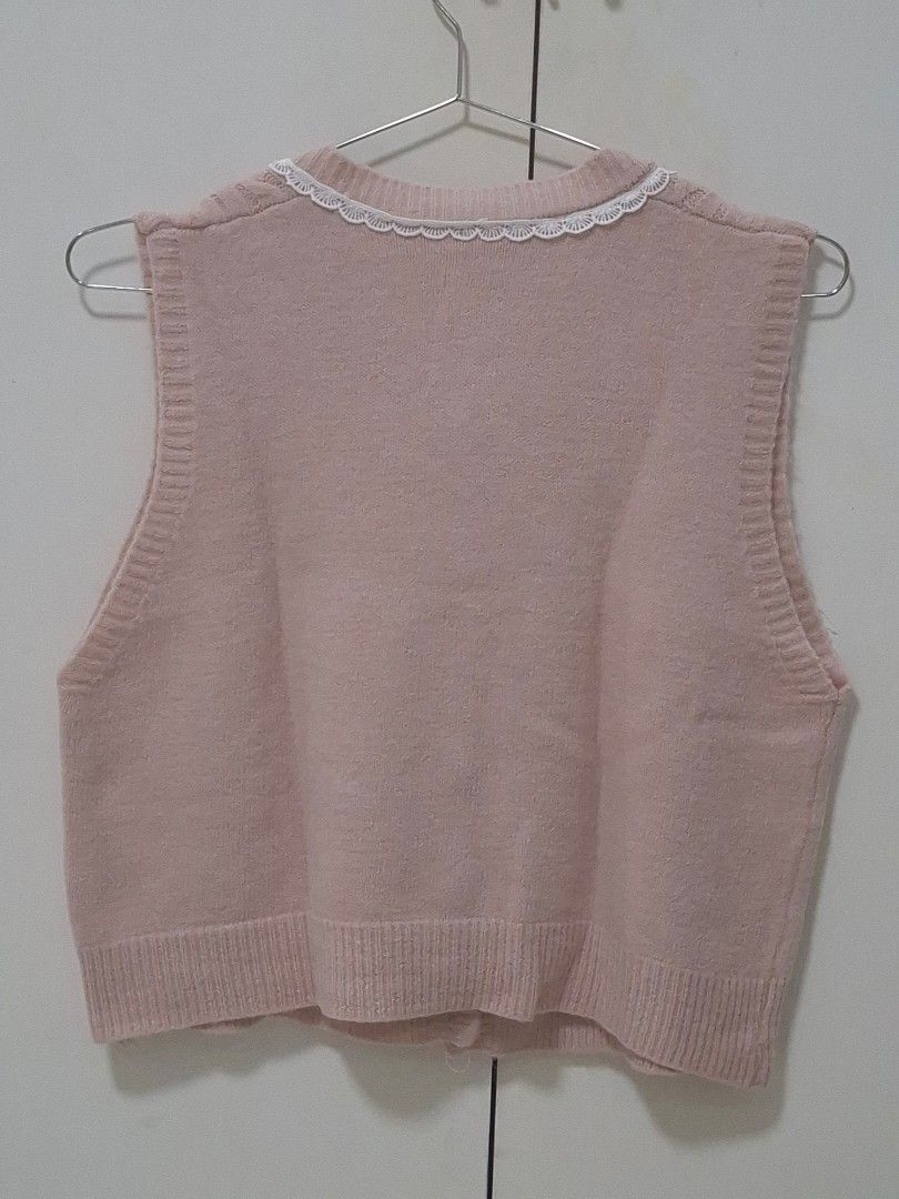 Pink Knit Vest (Category: Coats, Jackets and Outerwear) located in Manila. Submitted by preloved_tweeds_ph (Listing ID 1462615340, Image 2). Description: Only worn once - Adorable pink knitted vest - Features a classic cable knit pattern - Delicate lace trim around the neckline - Adjustable ribbon tie for a custom fit - Charming pearl button details - Sleeveless design, ideal for layering.