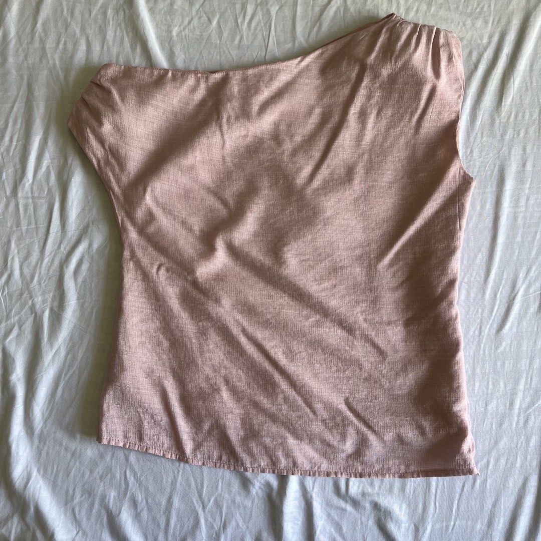 Pink Linen Off-the-Shoulder Blouse (Category: Blouses) located in Caloocan City. Submitted by daenty.mnl (Listing ID 1462469198, Image 1). Description: - used once only - bought for ₱1000 - Sheer linen fabric - Trendy off-the-shoulder design - Unique one-sleeve style - Flattering belted waist - Effortlessly feminine - Perfect for dressing up or down - Pairs beautifully with skirts or pants.