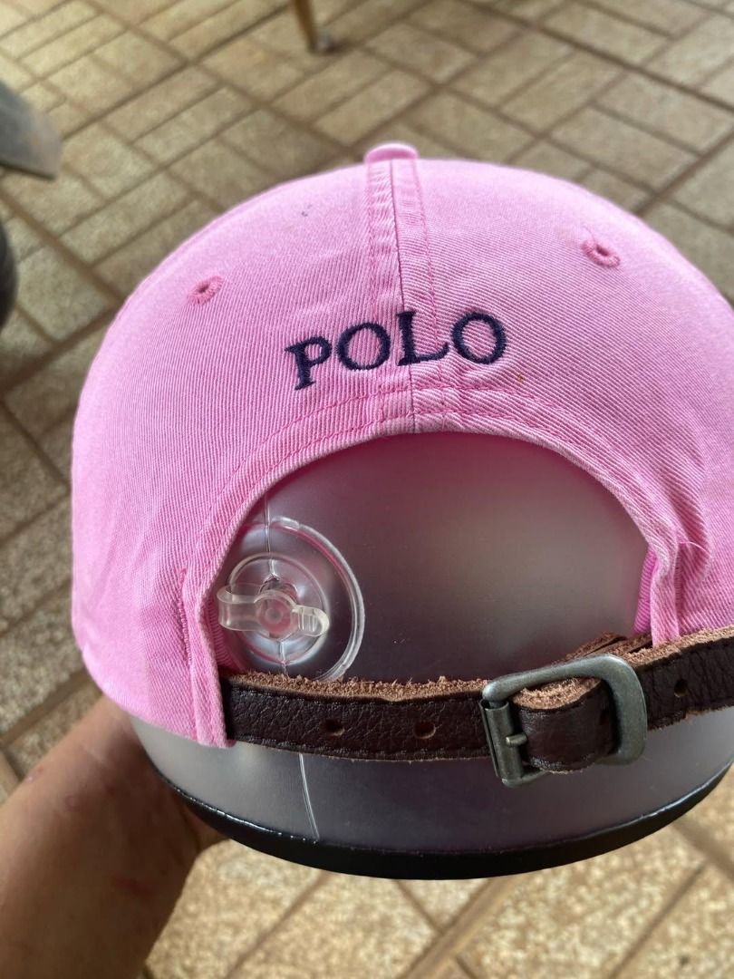 Pink Polo Ralph Lauren Cap (Category: Caps & Hats) located in Balanga. Submitted by innerbeautycloset (Listing ID 1462517504, Image 3). Description: - Classic pink Polo Ralph Lauren cap - Iconic navy blue polo player logo embroidered on front - Adjustable strap at the back for a comfortable fit - Perfect for casual wear.