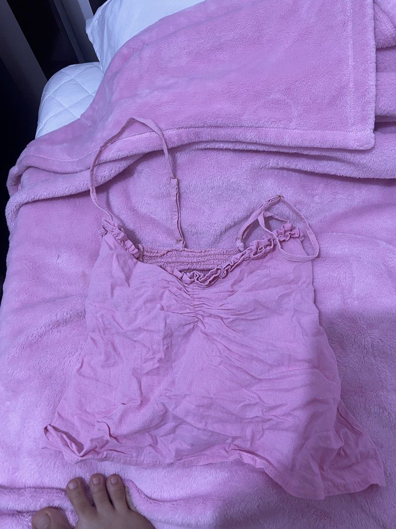 Pink Ruched Cami Top with Adjustable Straps (Category: Sleeveless) located in Manila. Submitted by boldflower.98829f (Listing ID 1462679688, Image 1). Description: - Adorable pink cami top - Features a ruched front with delicate ruffle details along the neckline - Adjustable straps for a perfect fit - Made from lightweight, crinkled fabric - Versatile for casual outfits or as a layering piece.