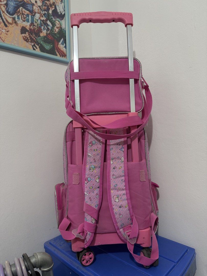 Pink Sanrio Characters Rolling Backpack with Matching Lunch Bag (Category: Backpacks) located in Binan City. Submitted by prelovedlagunaph (Listing ID 1462620155, Image 3). Description: - Adorable pink Sanrio rolling backpack set - Features beloved characters: Kitty, My Melody, and Little Twin Stars - Main backpack with wheels and retractable handle for easy rolling - Adjustable shoulder straps for comfortable carrying - Includes a matching small