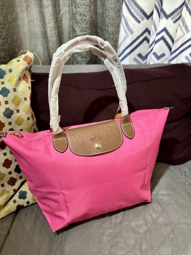 Pink Tote Neo Tote Bag (Category: Tote Bags) located in Rizal. Submitted by stuffbuyph (Listing ID 1462475961, Image 3). Description: - bright pink tote bag - Durable nylon material with elegant leather trim - Comfortable top handles for easy carrying - Secure zipper closure - Spacious interior, ideal for everyday essentials - Perfect for daily use.