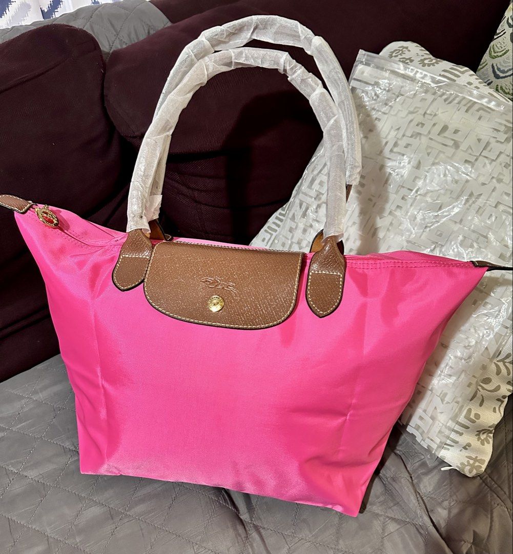 Pink Tote Neo Tote Bag (Category: Tote Bags) located in Rizal. Submitted by stuffbuyph (Listing ID 1462475961, Image 2). Description: - bright pink tote bag - Durable nylon material with elegant leather trim - Comfortable top handles for easy carrying - Secure zipper closure - Spacious interior, ideal for everyday essentials - Perfect for daily use.