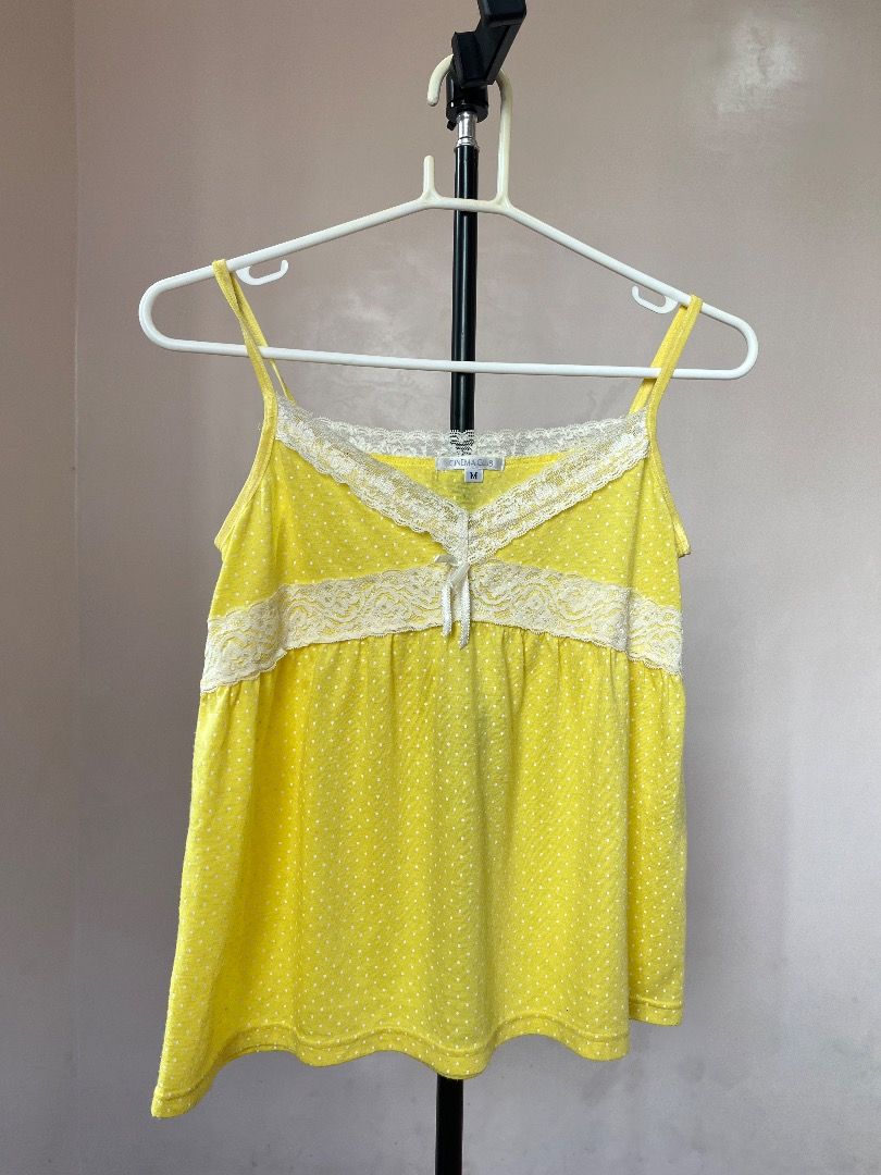 Polka dot top and midi skirt (Category: Sleeveless) located in Caloocan City. Submitted by luvv.kryx (Listing ID 1462498381, Image 2). Description: - Adorable yellow camisole top - Features a charming white polka dot pattern - Delicate lace trim around the neckline - Decorative tie detail at the front - Adjustable spaghetti straps for a perfect fit - Versatile for layering or wearing as a standalone piece.
