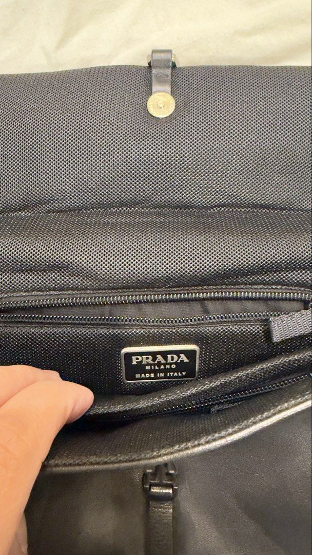 Prada Black Leather Handbag with Silver Buckle (Category: Luxury Bags & Wallets) located in Calamba. Submitted by doublegm (Listing ID 1462591035, Image 3). Description: - Authentic Black Leather Prada Handbag - Made in Italy - Main compartment with internal zip pockets - Silver buckle flap closure - Interior is clean - Minor signs of wear on leather and buckle consistent with use - Ideal for everyday carry.