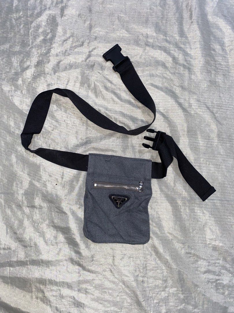 Prada Grey Canvas Waist Bag Belt Bag (Category: Luxury Bags & Wallets) located in Davao. Submitted by chazethrift (Listing ID 1462571113, Image 1). Description: - Grey canvas Prada waist bag - Front zippered pocket - Adjustable black strap with buckle closure - Small Prada logo triangle on the front - Ideal for keeping essentials easily accessible.
