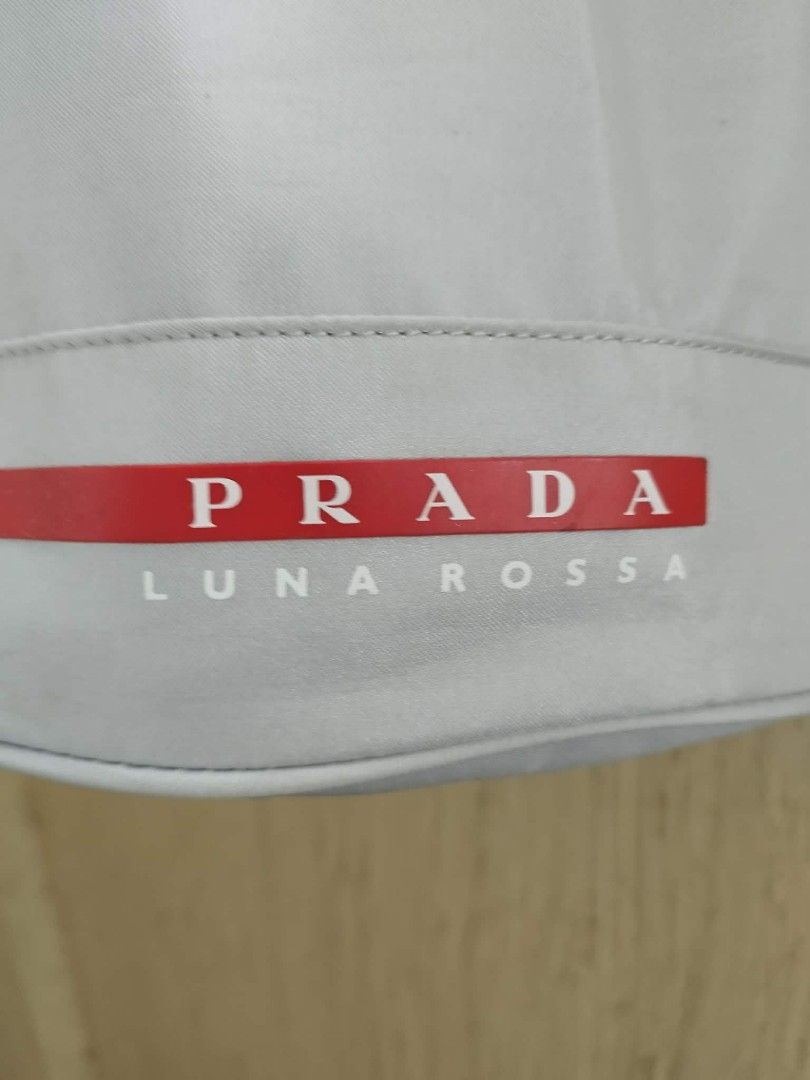Prada Luna Rossa Drawstring Backpack (Category: Luxury Bags & Wallets) located in Las Pinas. Submitted by anggesmart (Listing ID 1462505041, Image 3). Description: - Authentic Prada Luna Rossa drawstring bag - Color: Light Grey - Adjustable straps for comfortable carrying - Spacious interior - Ideal for gym or travel -Needs cleaning.