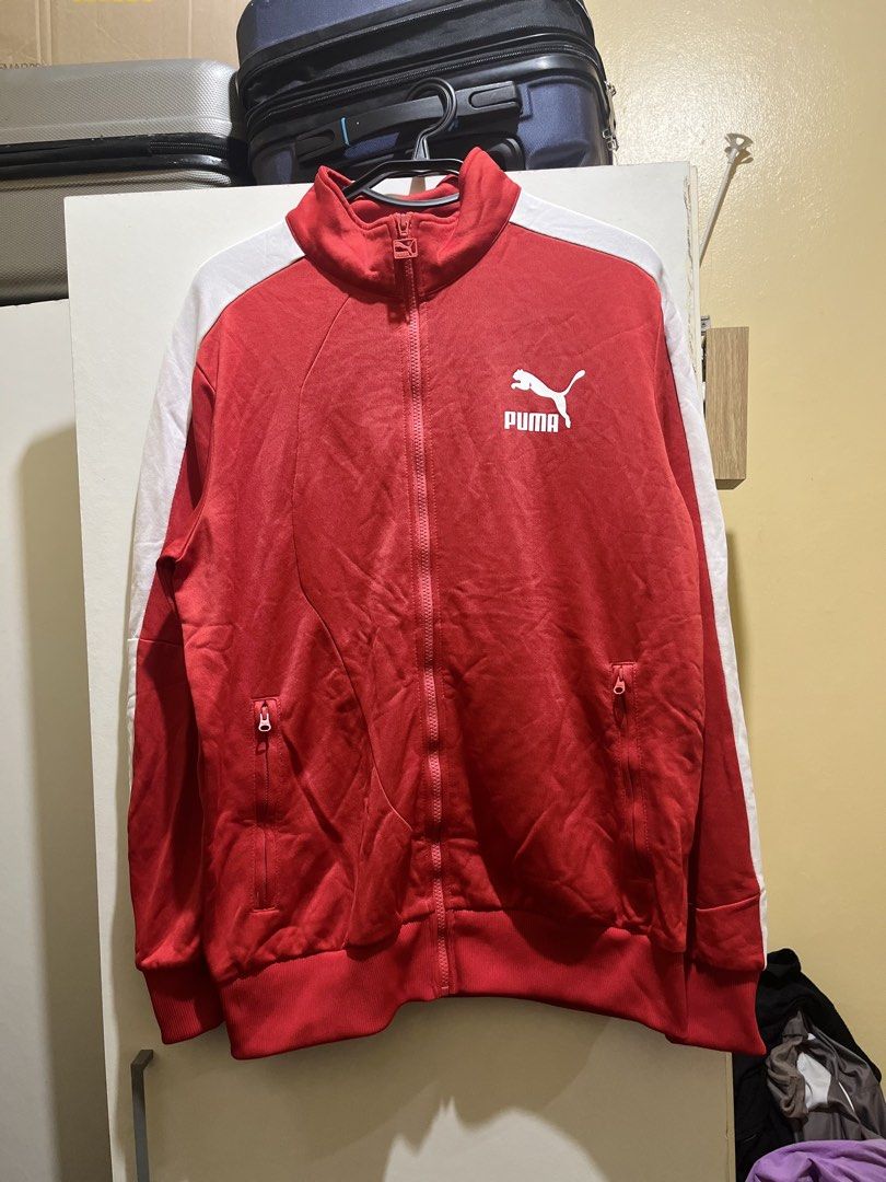 Puma Red Track Jacket with White Stripes - Size XL (Category: Coats, Jackets and Outerwear) located in Manila. Submitted by jezrathrift (Listing ID 1462672998, Image 1). Description: - Classic Puma track jacket in vibrant red. - Iconic white stripes accent the sleeves. - Features the recognizable Puma logo on the chest. - Full zip closure for easy wear. - Convenient front pockets for essentials. - Ribbed cuffs and hem for a comfortable fit. - Siz