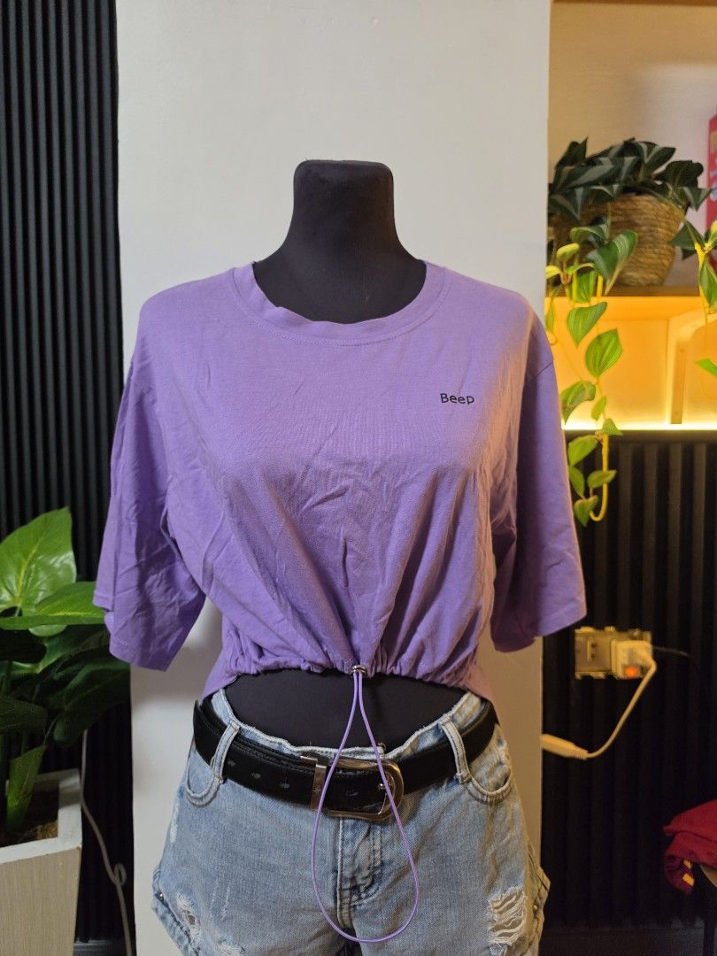 Purple Cropped T-shirt with Drawstring Detail medium (Category: Shirts) located in Paranaque City. Submitted by franinnashop (Listing ID 1462609242, Image 1). Description: - Adorable purple cropped t-shirt - Adjustable drawstring hem for a customized fit - 'Beep' embroidery detail on the chest - Versatile: pairs perfectly with shorts or jeans - Comfortable and stylish for everyday wear declutter medium paranaque city.