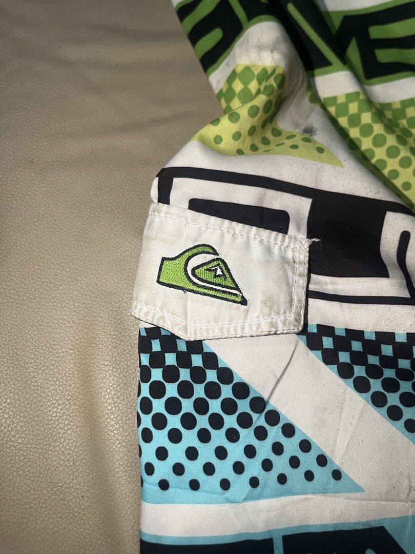 Quiksilver Board Shorts Size 36 (Category: Swim Trunks & Board Shorts) located in Lapu Lapu. Submitted by vanzfinds_16 (Listing ID 1462615642, Image 3). Description: - Quiksilver Board Shorts - Size: 36 - Design: Bold geometric and dot pattern (white, green, blue, black) - Features: Velcro pocket on right side, adjustable drawstring waist - Ideal for: Swimming, lounging, beach activities.