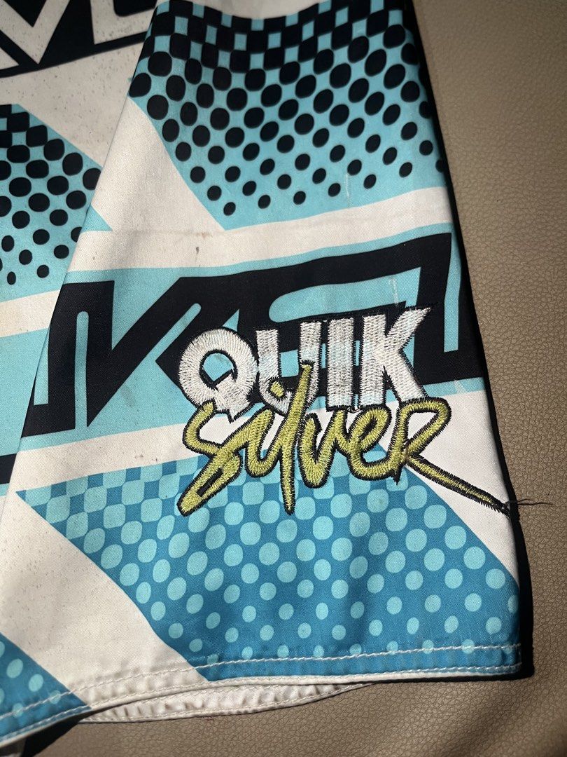 Quiksilver Board Shorts Size 36 (Category: Swim Trunks & Board Shorts) located in Lapu Lapu. Submitted by vanzfinds_16 (Listing ID 1462615642, Image 2). Description: - Quiksilver Board Shorts - Size: 36 - Design: Bold geometric and dot pattern (white, green, blue, black) - Features: Velcro pocket on right side, adjustable drawstring waist - Ideal for: Swimming, lounging, beach activities.