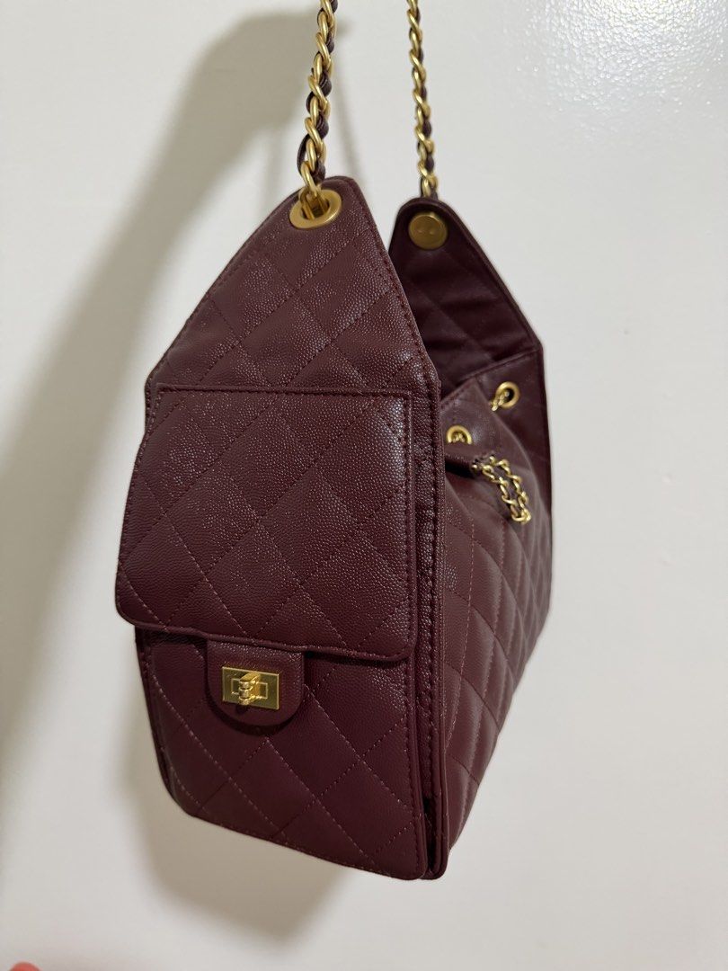 Quilted Drawstring Chain Shoulder Bag Burgundy (Category: Shoulder Bags) located in Marilao. Submitted by anp129 (Listing ID 1462452739, Image 3). Description: - Chic burgundy quilted handbag - Elegant gold chain strap - Secure drawstring closure - Convenient front flap pocket - Beautiful textured finish - Stylish gold hardware details - Versatile for everyday or evening wear.