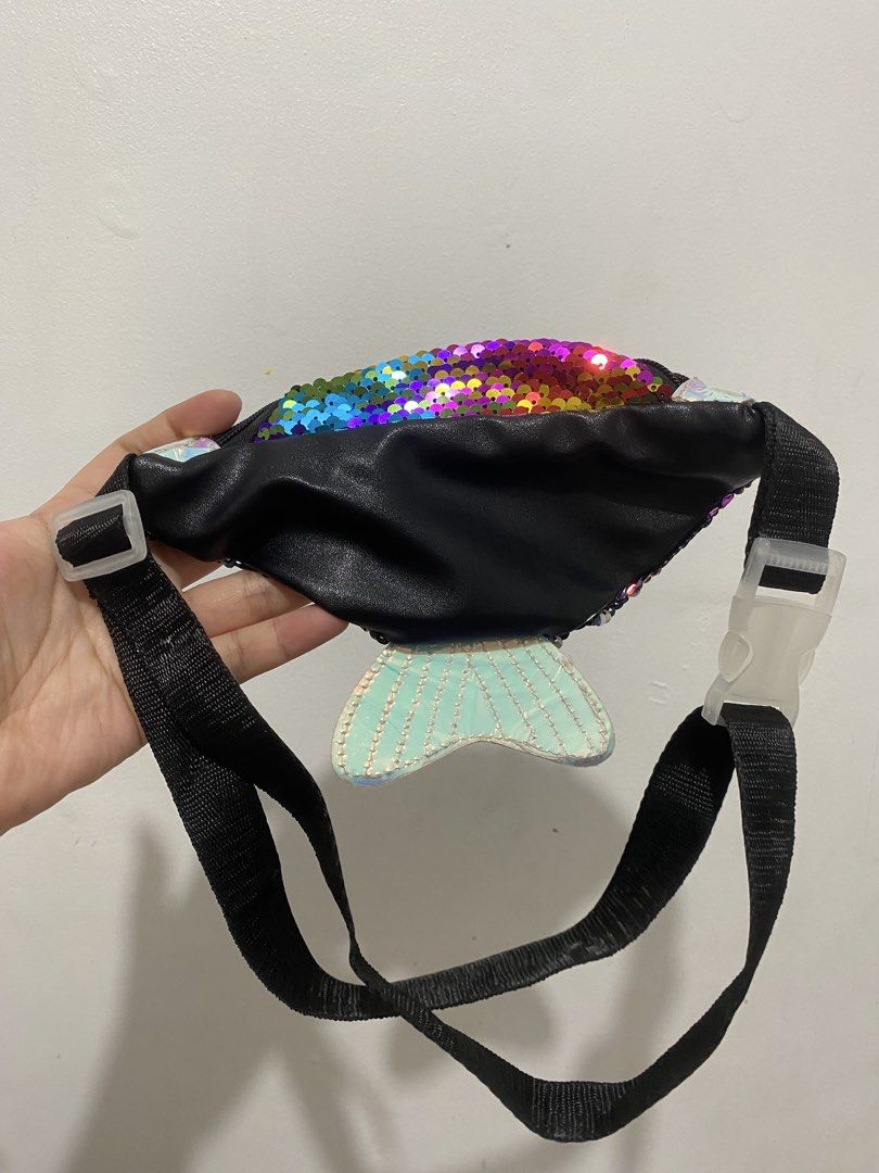 Rainbow Sequin Mermaid Tail Belt Bag (Category: Purses & Pouches) located in Binan City. Submitted by prelovedlagunaph (Listing ID 1462620524, Image 2). Description: - Super cute fanny pack with dazzling rainbow sequins - Features a sparkly mermaid tail detail at the back - Adjustable strap with a secure buckle closure - Zippered main compartment for your essentials - Ideal for festivals, parties, or adding everyday fun - A fun accessory for both