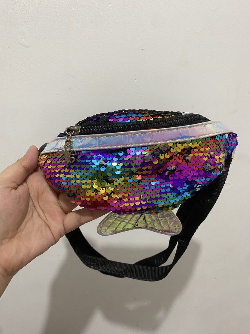 Rainbow Sequin Mermaid Tail Belt Bag (Category: Purses & Pouches) located in Binan City. Submitted by prelovedlagunaph (Listing ID 1462620524, Image 1). Description: - Super cute fanny pack with dazzling rainbow sequins - Features a sparkly mermaid tail detail at the back - Adjustable strap with a secure buckle closure - Zippered main compartment for your essentials - Ideal for festivals, parties, or adding everyday fun - A fun accessory for both